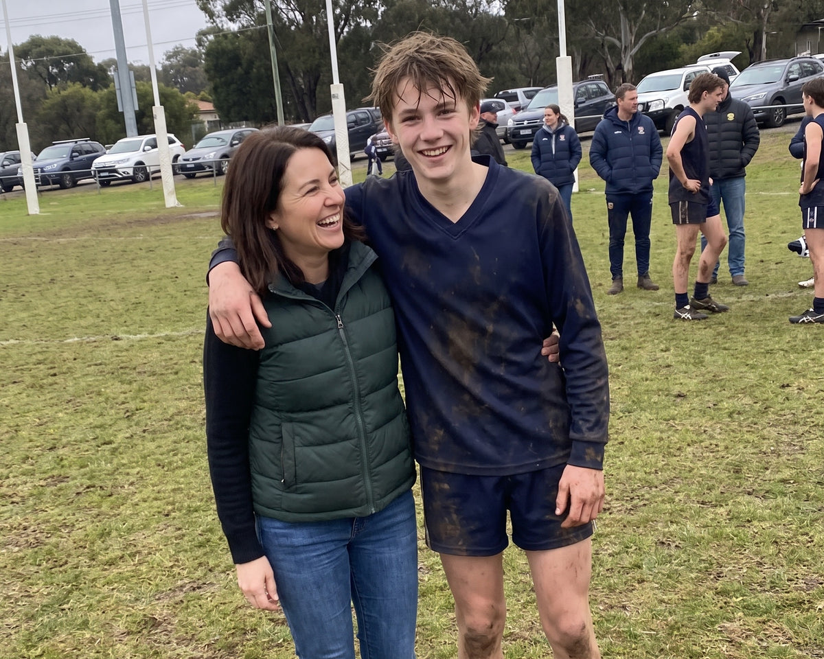 Kate and her son Lachlan at his footy game
